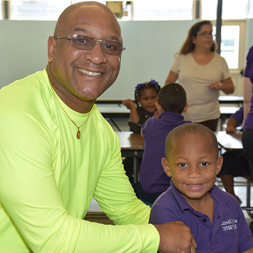 Father and son smiling at camera