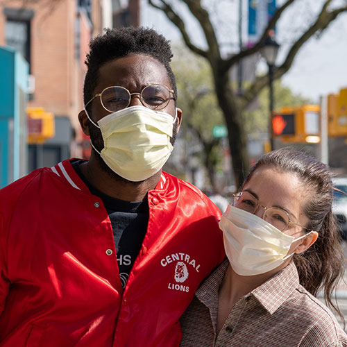 friends wearing face masks in the street